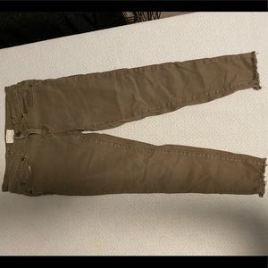 Army green skinny jeans with distressed ankles